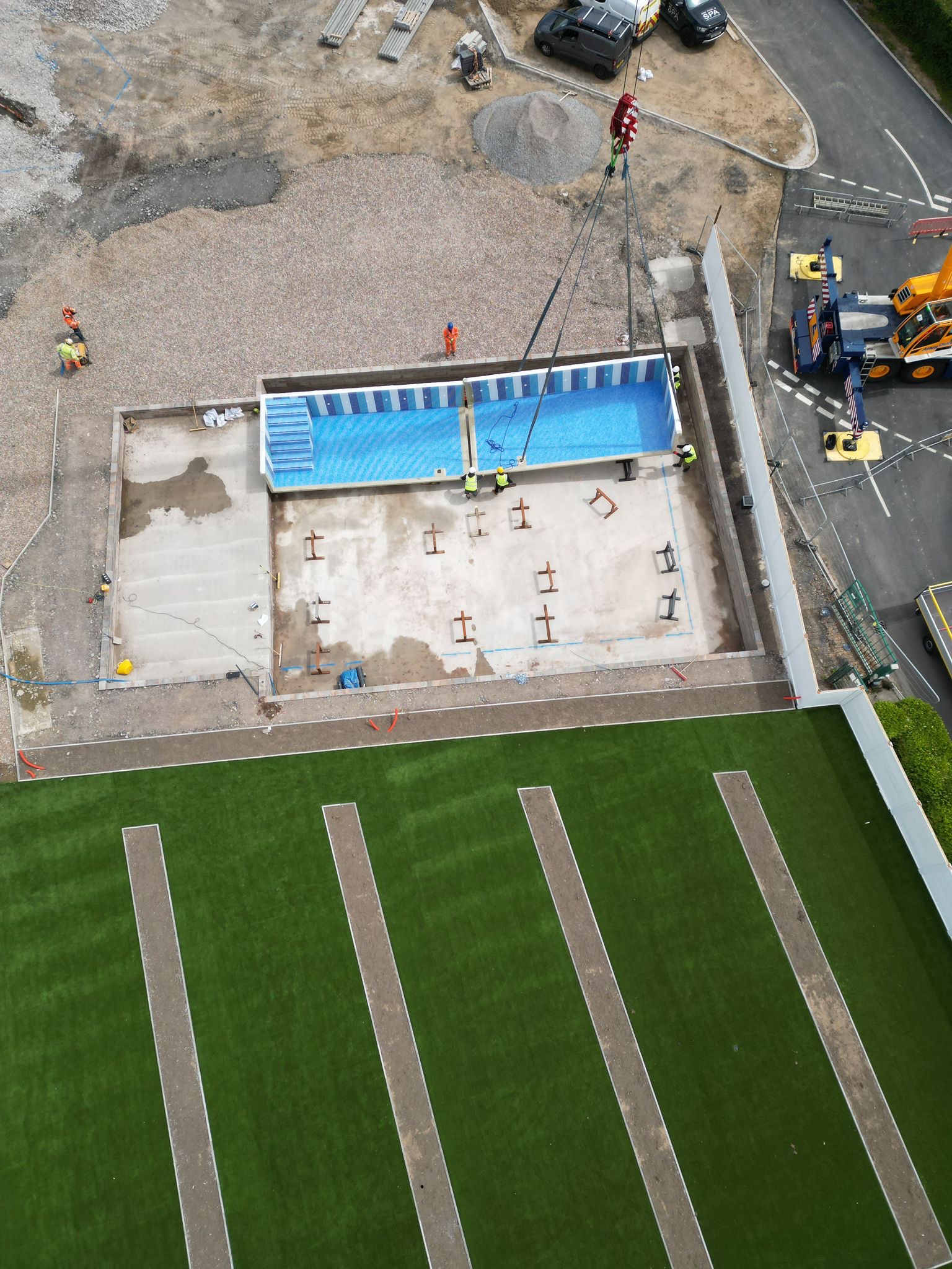Aerial view of the reinforced concrete pool base with the first pool section in place