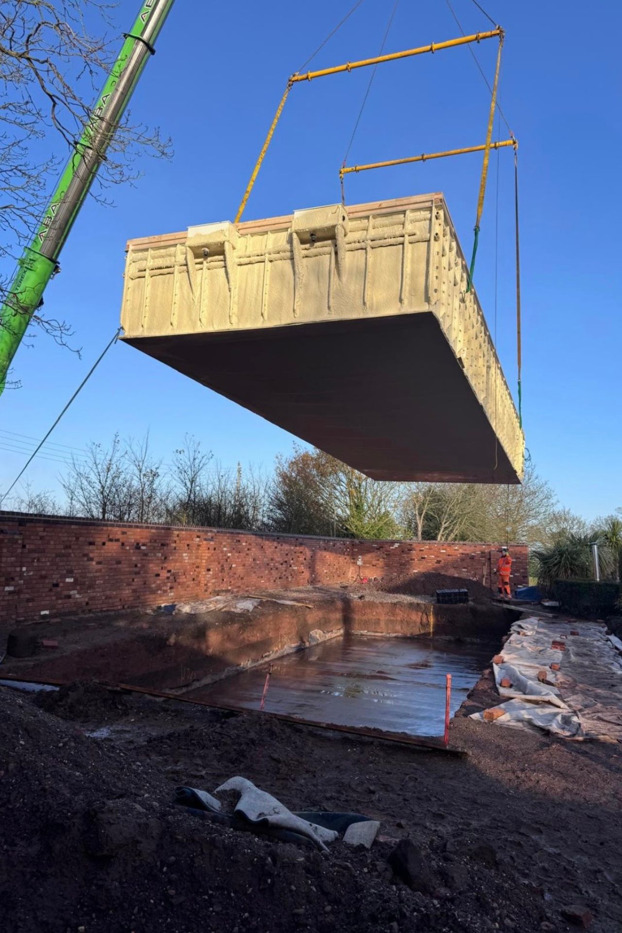 One-piece Flexline pool shell lowered into the excavation