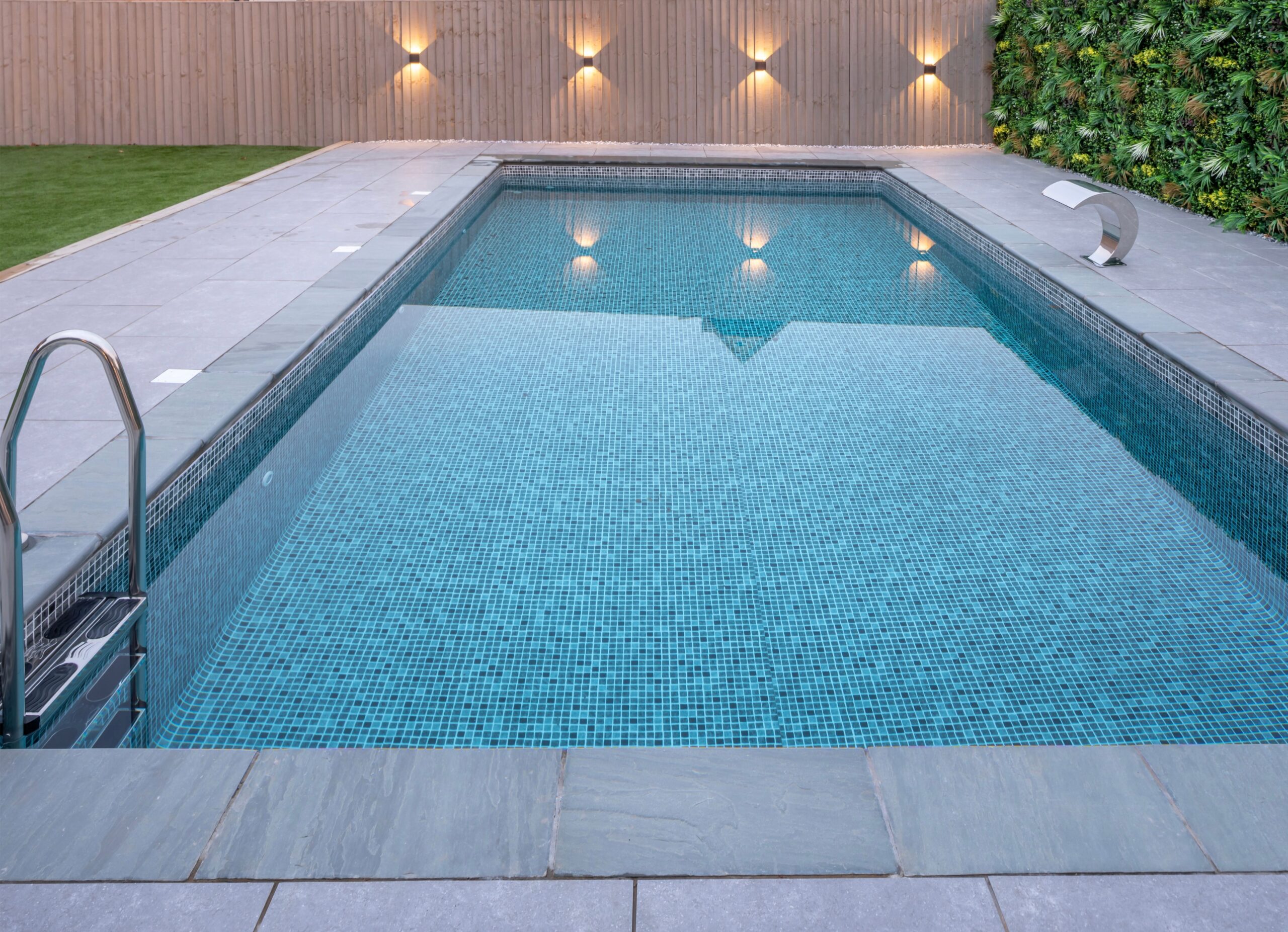 Wooden swimming pool set into a landscaped garden