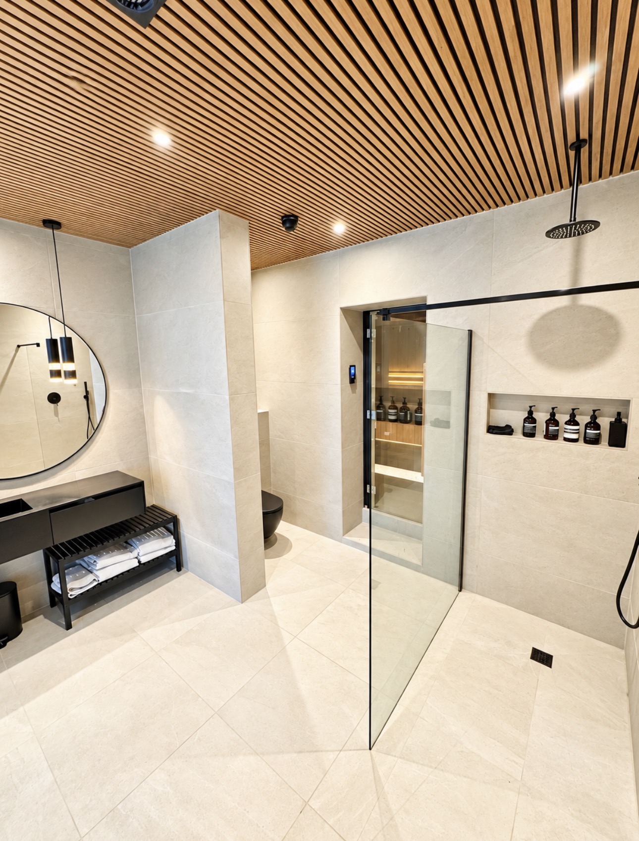 Walk-in shower and vanity area beside the pool room
