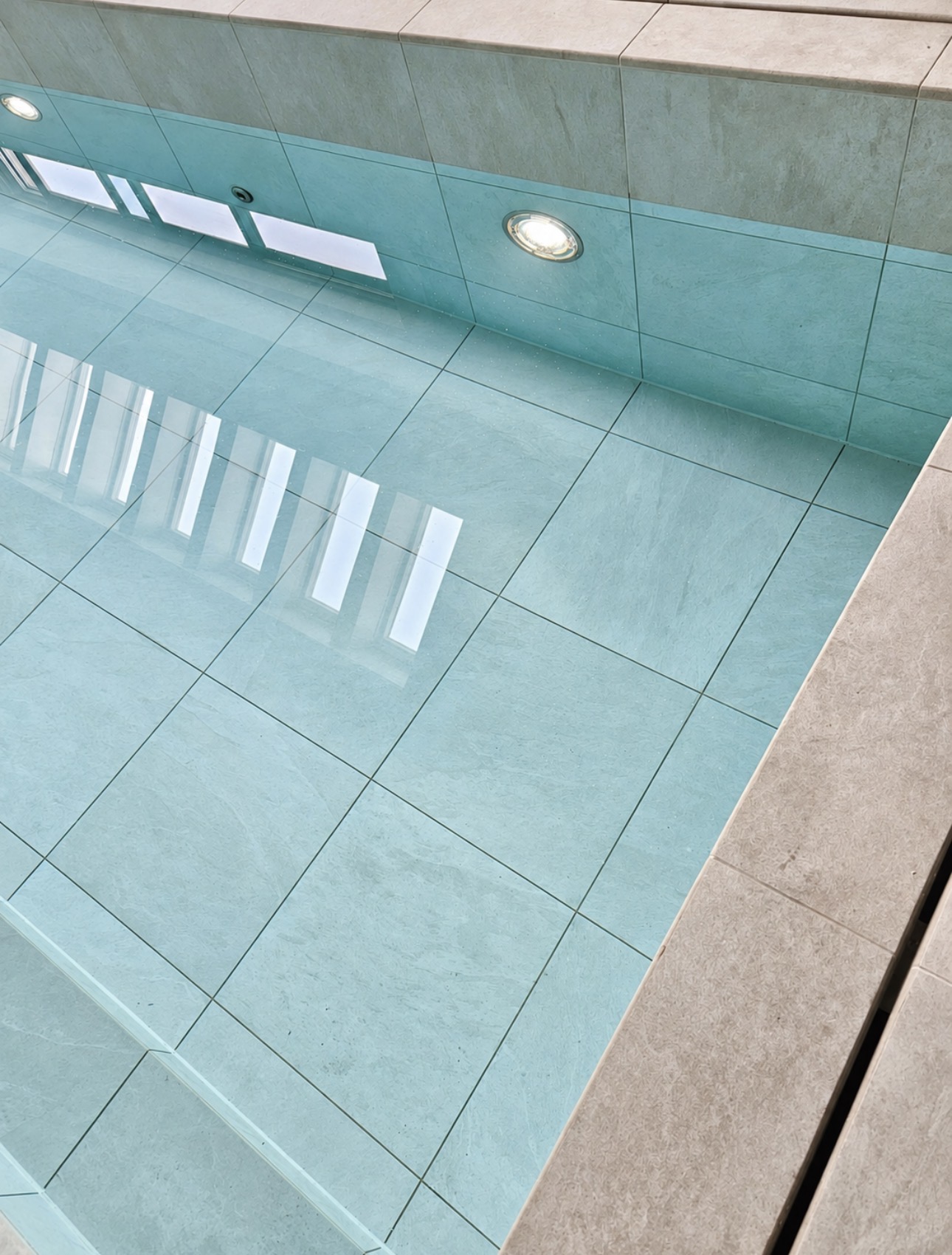 Close-up of large-format porcelain tiles inside the pool