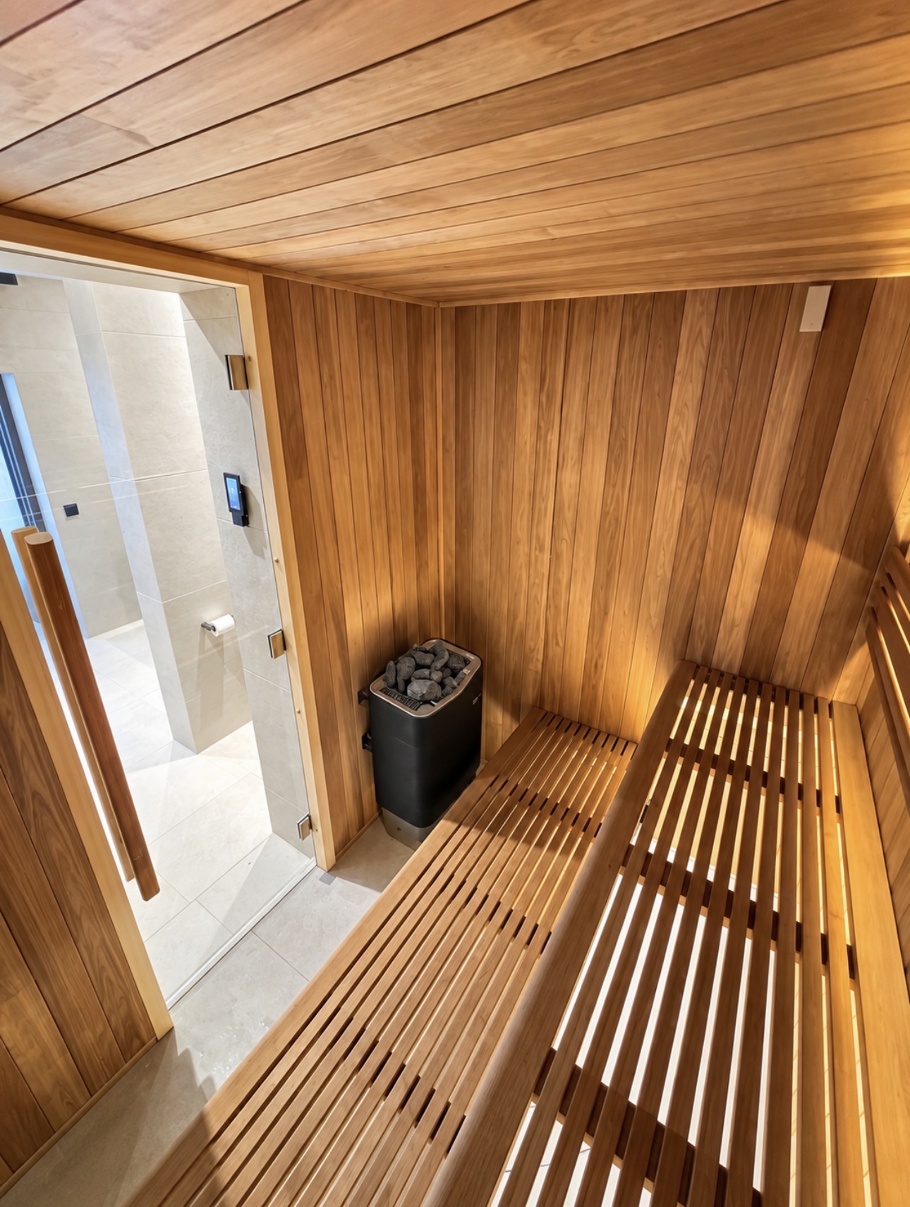 Timber-lined sauna next to the pool room