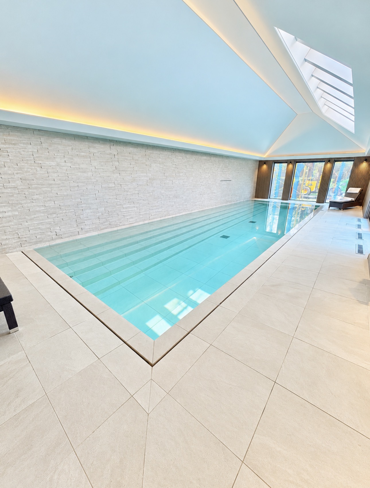 Wide view of the refurbished pool with full-width entry steps