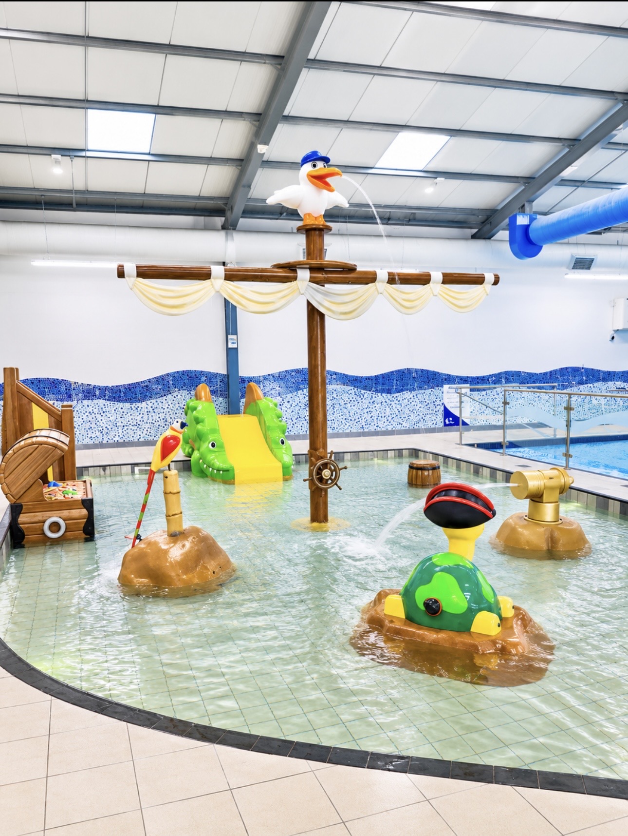 Finished children's splash pool with the main swimming pool beyond
