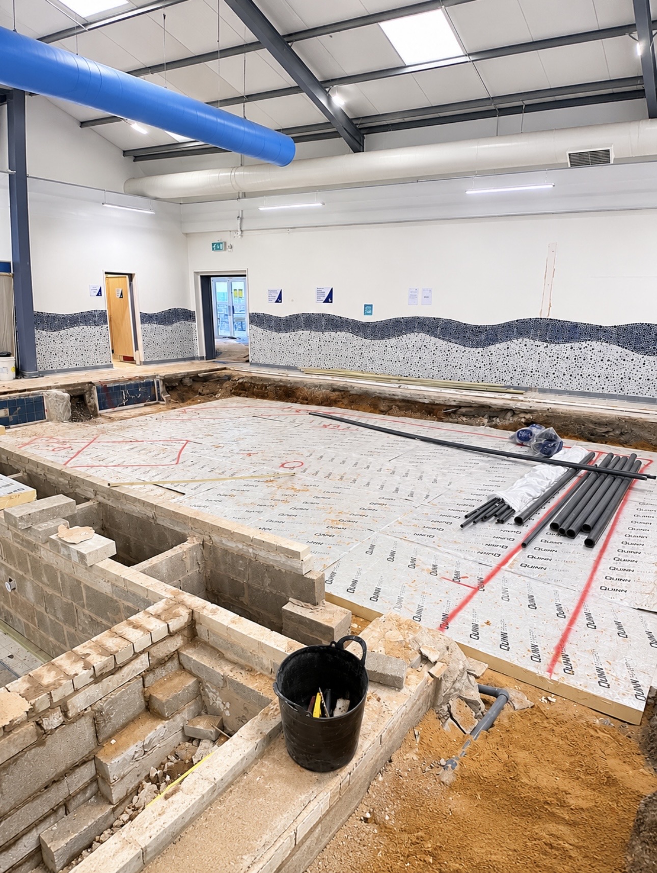 Blockwork and insulation going in for the splash pool, with pipework laid out